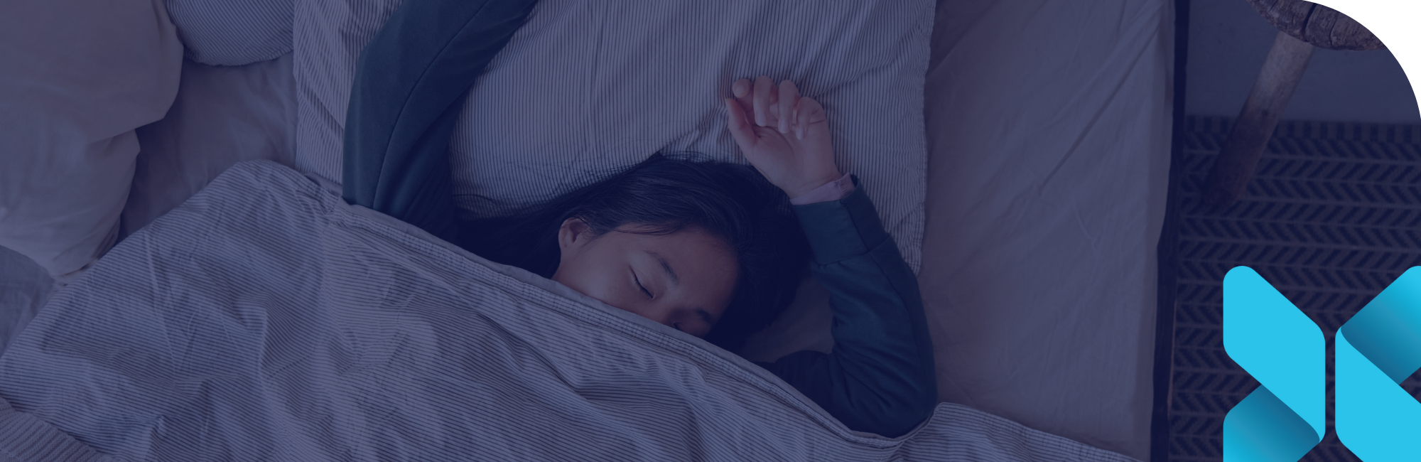 girl laying in bed with eyes closed and blanket on top of her